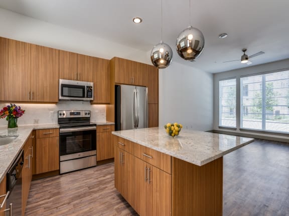 a kitchen with wooden cabinets and stainless steel appliances