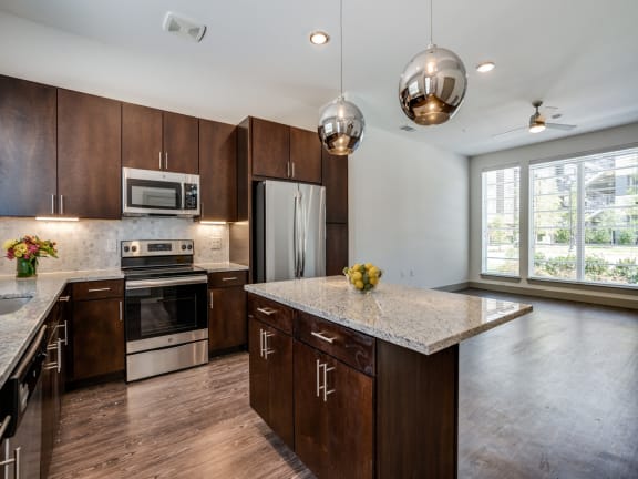 a kitchen with wooden cabinets and stainless steel appliances
