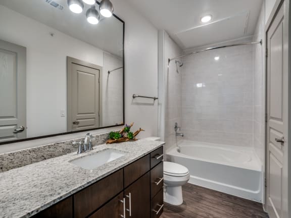 the retreat apartment homes ensuite bathroom with tub and shower