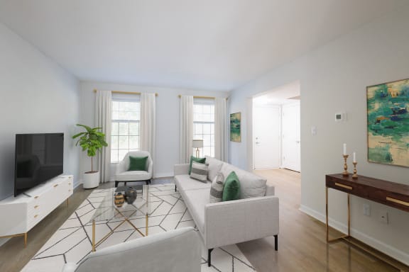 a living room with couches and chairs and a television