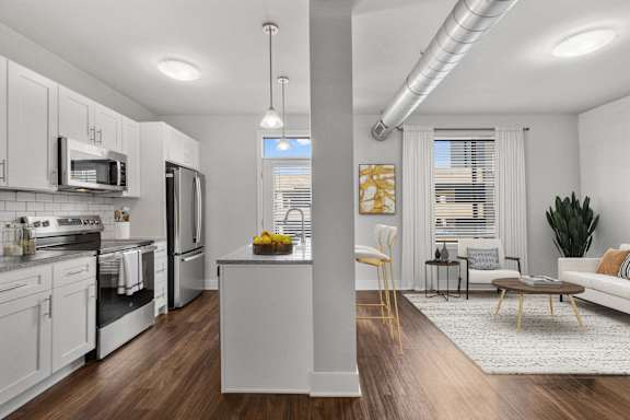 A modern kitchen with white cabinets and stainless steel appliances at CityWay Apartments, Indianapolis, 46204