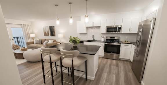 A modern kitchen with a dining area and a refrigerator.