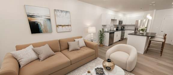 A living room with a brown couch and a coffee table.