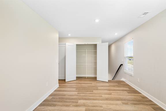 A room with a wooden floor and white walls. at Mural Lewis Center, Lewis Center, 43035