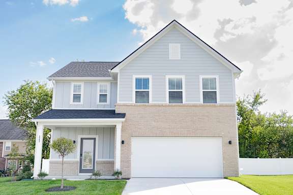 A two-story house with a garage on the right side.