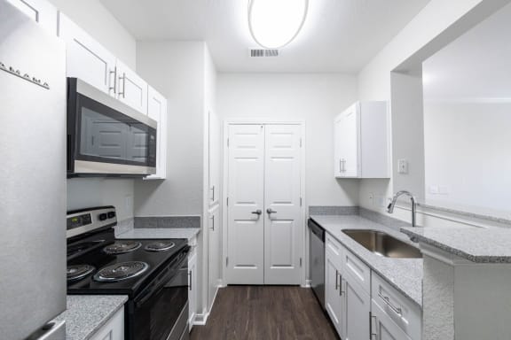 Kitchen with cabinets at Center Point Apartments, Indianapolis, 46214