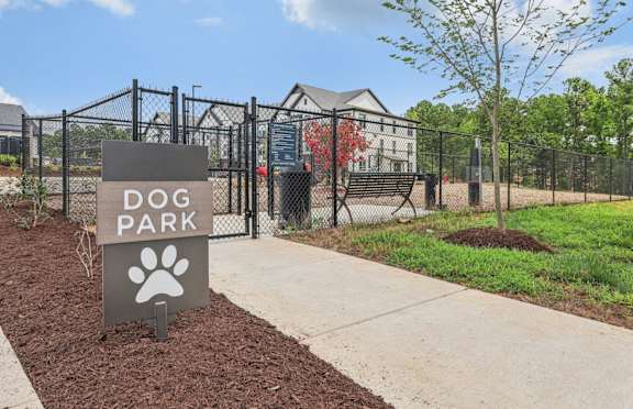 a dog park sign in front of a fence and a dog at Nook Nine, Indianapolis, 46240