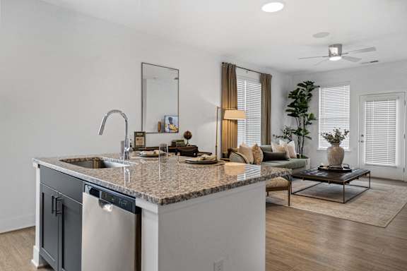 Open-concept kitchen at Nook Nine with granite island, stainless steel appliances, and modern finishes.