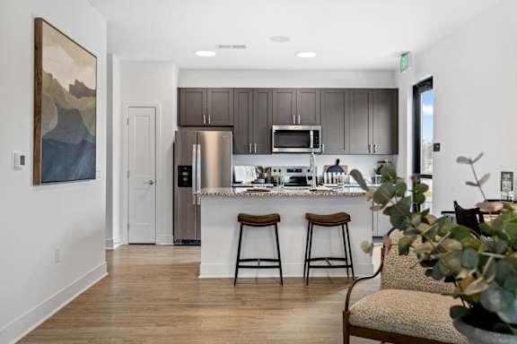 Modern kitchen at Nook Nine with granite countertops, stainless steel appliances, and sleek cabinetry.
