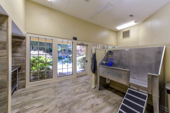 a pet washing room with sink and dryers