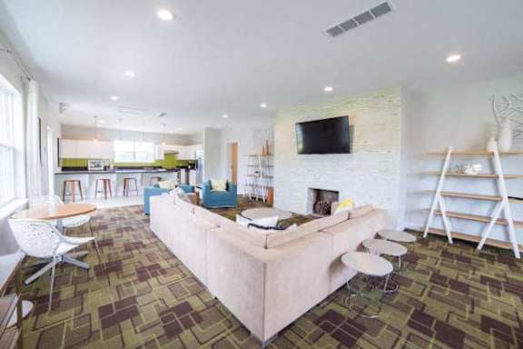 A living room with a fireplace and a couch at Gramercy Apartments, Indiana, 46032