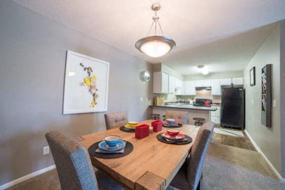Well-designed dining area with wooden furniture at Gramercy Apartments, Indiana, 46032