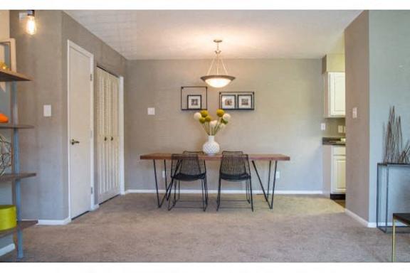 A dining room with a table and chairs at Gramercy Apartments, Carmel