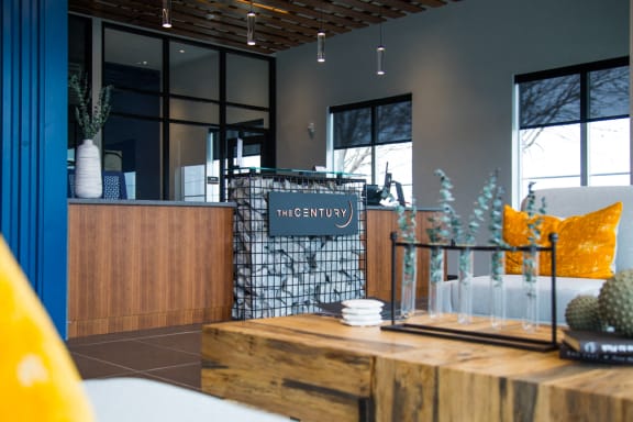 a restaurant with a wooden table and a sign that reads the creativity at The Century at Purdue Research Park-Student, West Lafayette