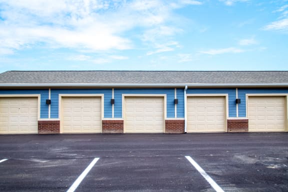 a row of garage doors in a parking lot at The Century at Purdue Research Park-Student, West Lafayette