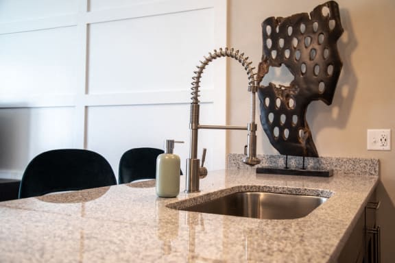 a kitchen counter with a sink and a soap dispenser at The Century at Purdue Research Park-Student, West Lafayette, 47906
