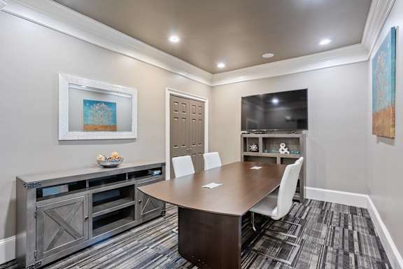 A conference room with a wooden table and chairs at Village at Almand Creek, Conyers, Georgia