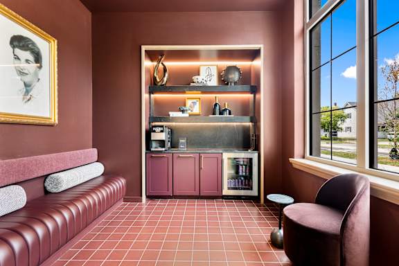 A boldly colored lounge with coffee and beverage station at The Beverly.
