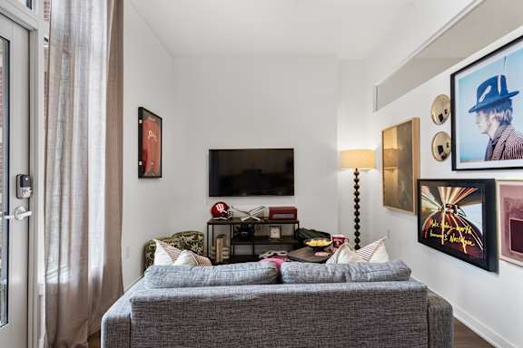 A living room with a grey couch and a television.