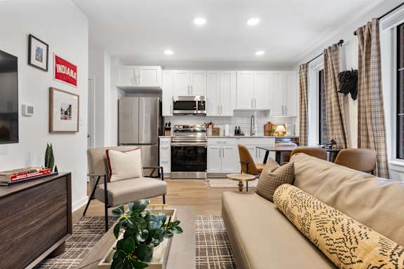 A guest suite living room with a couch, chairs, and a coffee table.