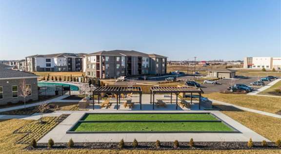 A large building complex with a green lawn in front at Echo Park at Perry Crossing Apartments, Indiana, 46168