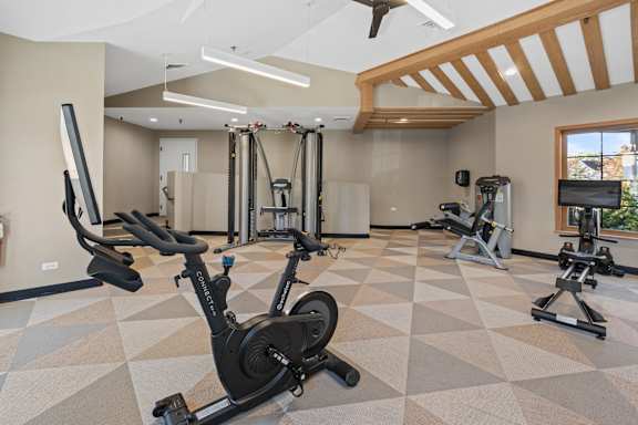 the gym in the owners home has exercise equipment and treadmills at The Winds at Poplar Creek Apartments , Schaumburg, IL, 60194