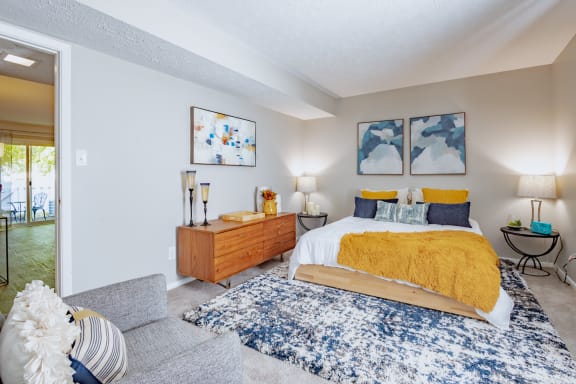 a bedroom with a bed and a couch