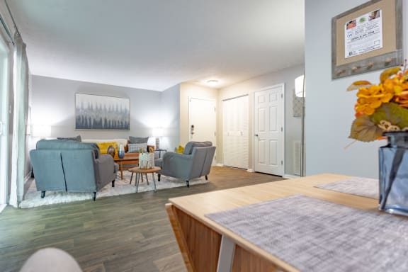 a living room with couches and chairs and a dining table
