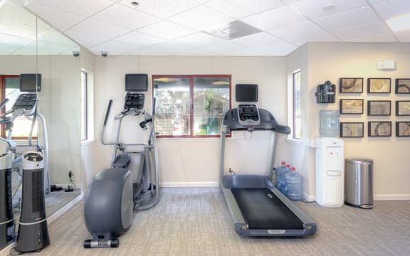 a room with treadmill  and exercise bike