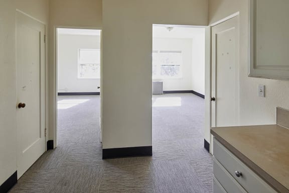 an empty room with a doorway leading into another room at MILEPOST 5 Apartments, PORTLAND