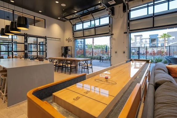 A modern bar with a long wooden counter and a large window overlooking the street at 38° NORTH, Santa Rosa