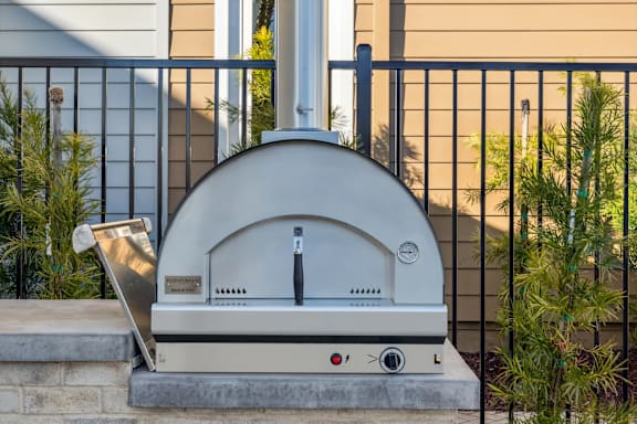 A wood-fired oven is placed on a patio at 38° NORTH, California