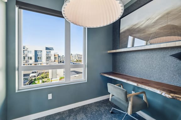 A room with a large window overlooking a street with buildings at 38° NORTH, Santa Rosa, CA, 95404