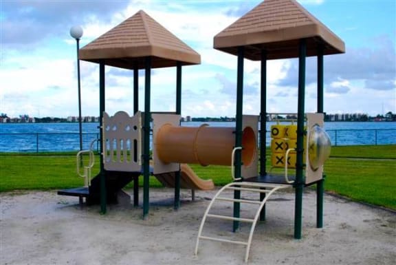 Dog-Friendly Affordable Apartments in Oakland Park, FL - Aqua 2800 Apartments - An Enclosed Playground Looking Out on the Water at Aqua 2800, Oakland Park