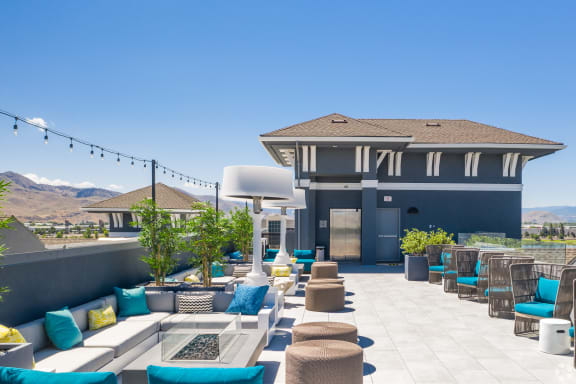 Rooftop pool deck, fire pit, and gathering area with patio heaters