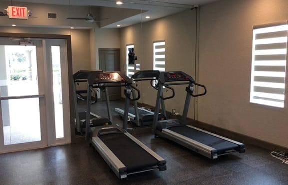 fitness center with treadmills at The Edge at Town Center Apartments, Florida