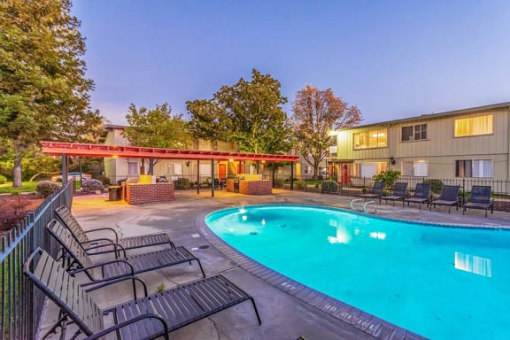 Pool with lounge chairs l Cottage Bell Apartments in Sacramento CA