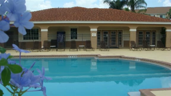 Pool with lounge chairs at Hawk's Landing Apartments, Fort Myers, Florida