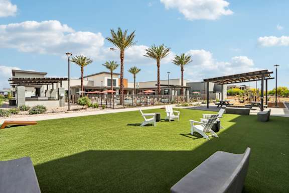 A sunny day at the park with palm trees and a playground at Ironwood Ranch Apartments,Maricopa,85138