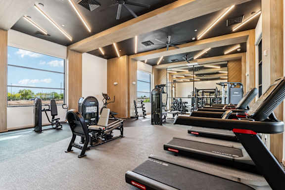 A gym with treadmills, weights, and exercise equipment at Ironwood Ranch Apartments,Maricopa,Arizona