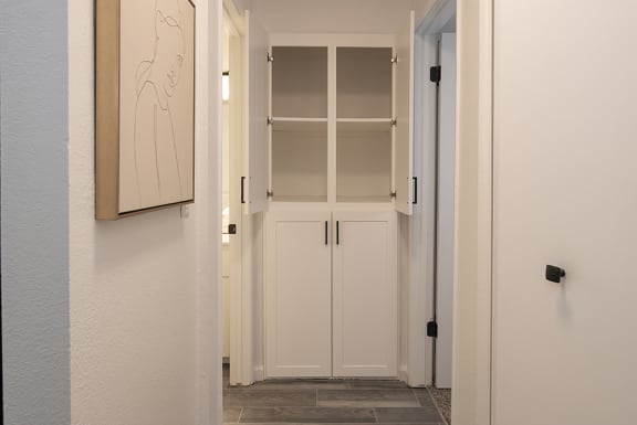 a hallway with white cabinets and a picture on the wall&#xA0;at THE ARLO, Citrus Heights, 95621