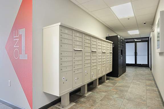 A row of mailboxes are lined up in a hallway at LOFT 205 Apartments, Reno, Nevada