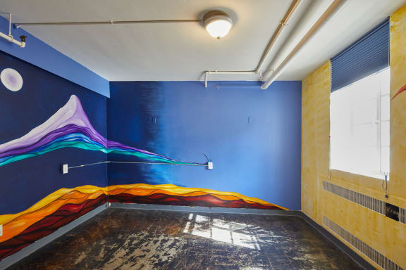 a painting of a wave in a blue room at MILEPOST 5 Apartments, PORTLAND Oregon