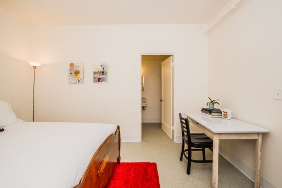 a bedroom with a bed and a desk at MILEPOST 5 Apartments, PORTLAND
