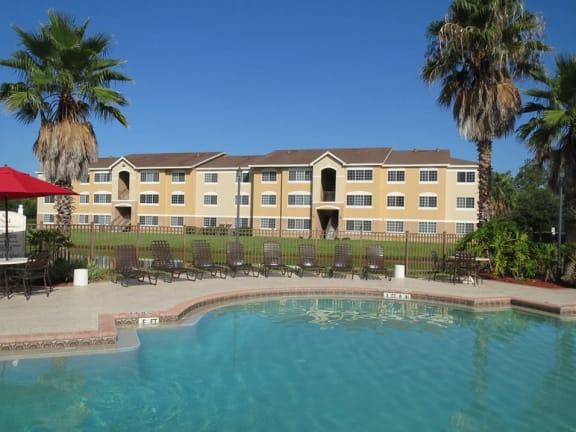 Pool with lounge chairs at Carolina Club Apartments, Daytona Beach