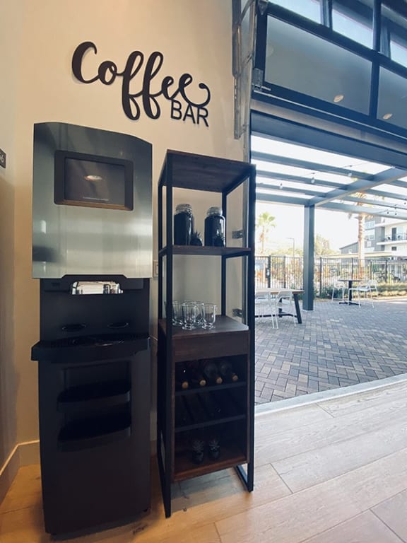 a coffee bar with a television and a refrigerator