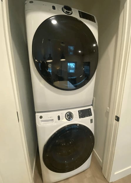 a front load washer and dryer in a laundry room