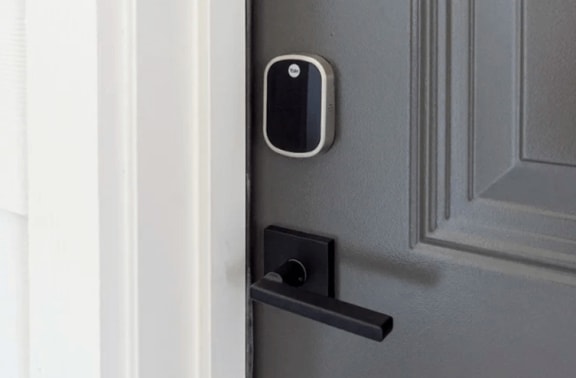 a black and white door handle on a gray door