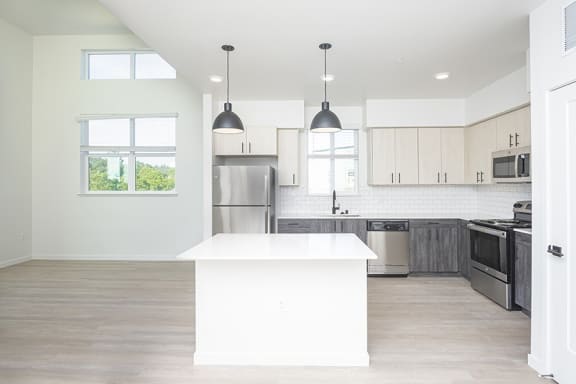 a kitchen with white cabinets and a white island