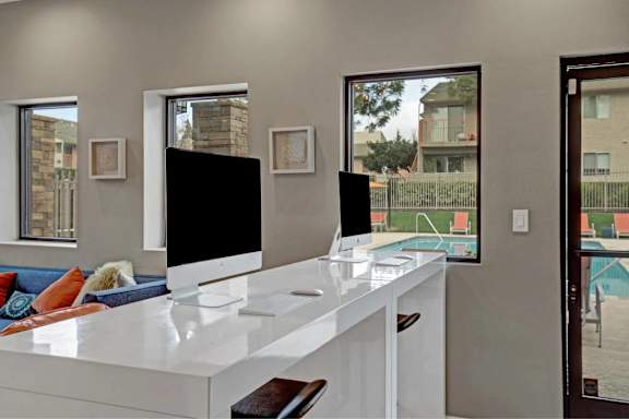 A modern living room with a white countertop and a television at The Henley Apartments, Suisun City, CA, 94585